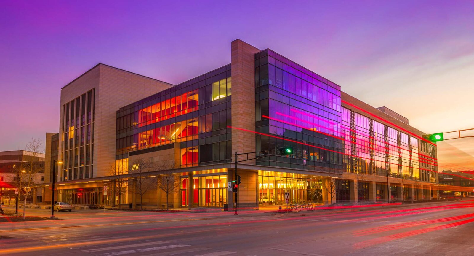 A street view photo of the Wisconsin Institute for Discovery with the purple sky in the background.