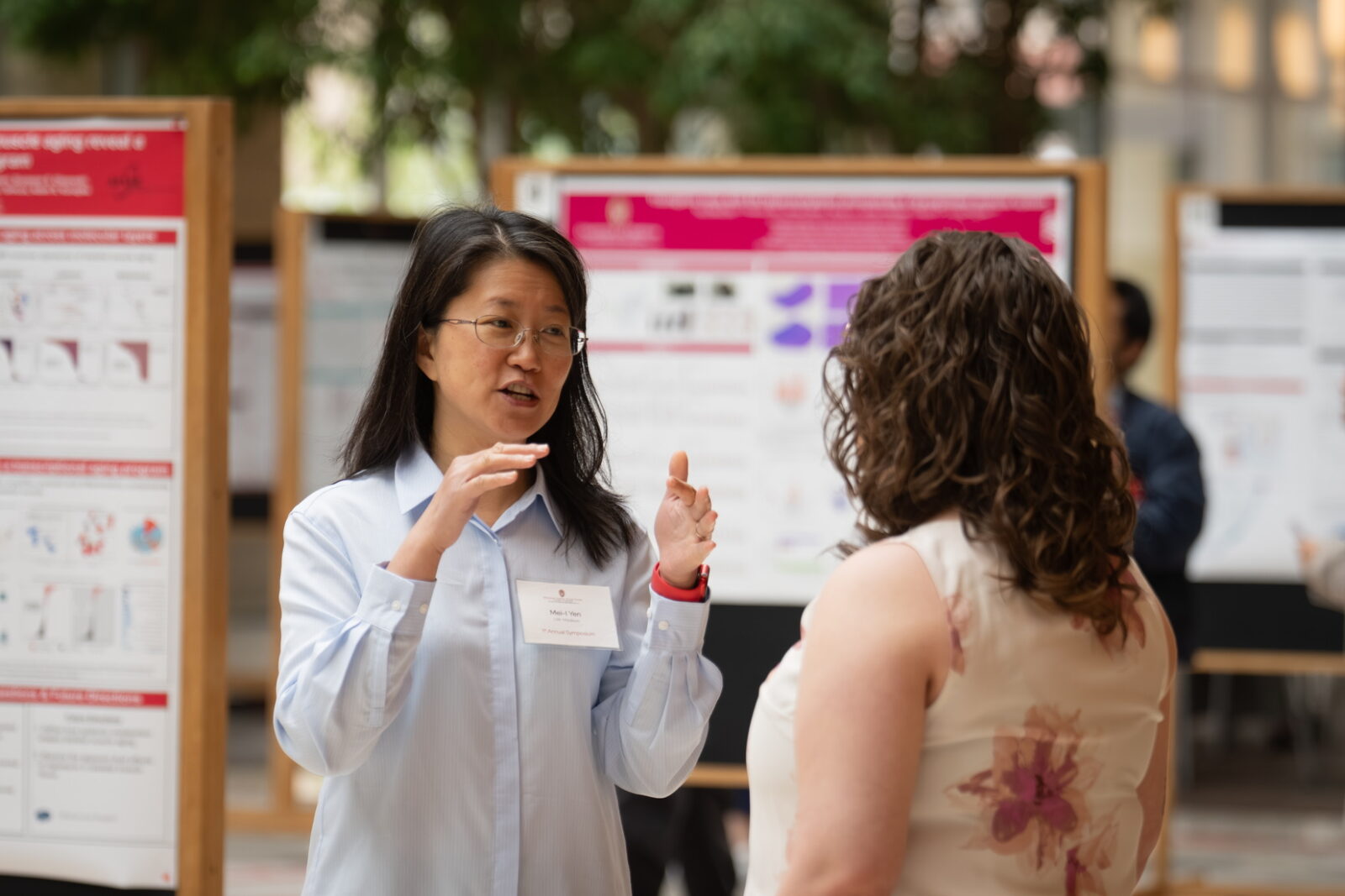 Image of attendees engaged in discussion during the WiNSC Symposium poster session and networking reception.