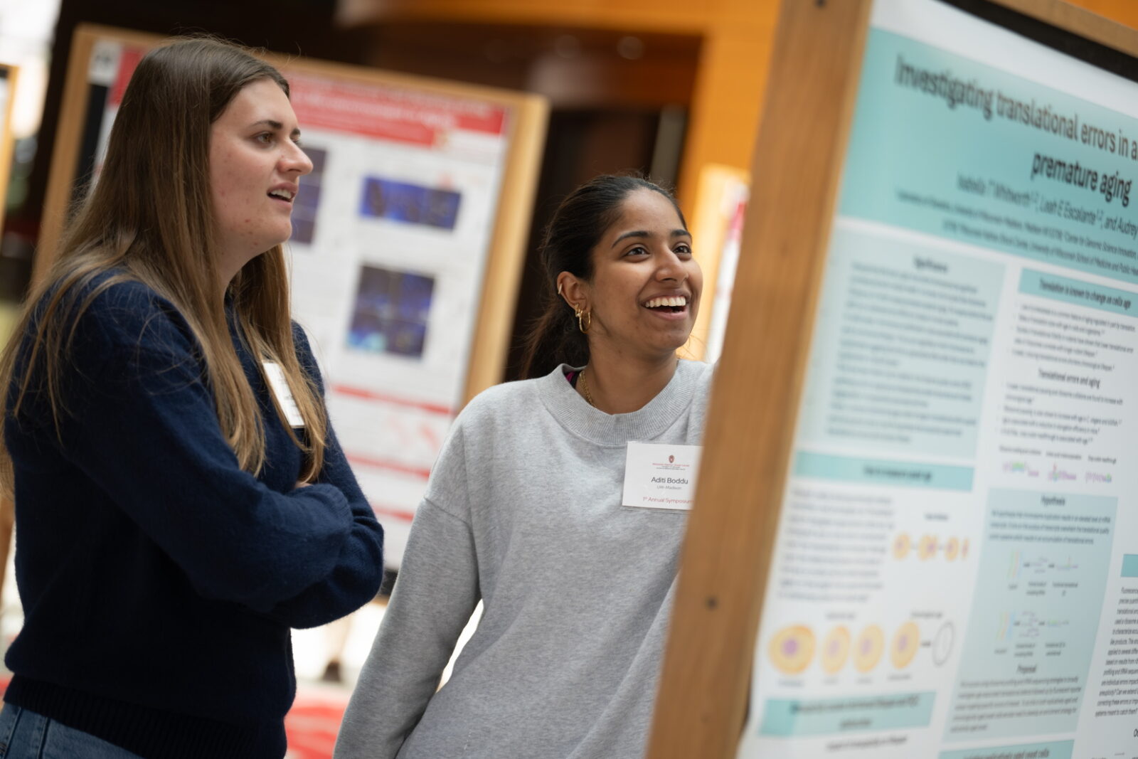 Image of neuroscience trainees engaged in discussion during the research poster session at the 2026 WiNSC Annual Symposium.