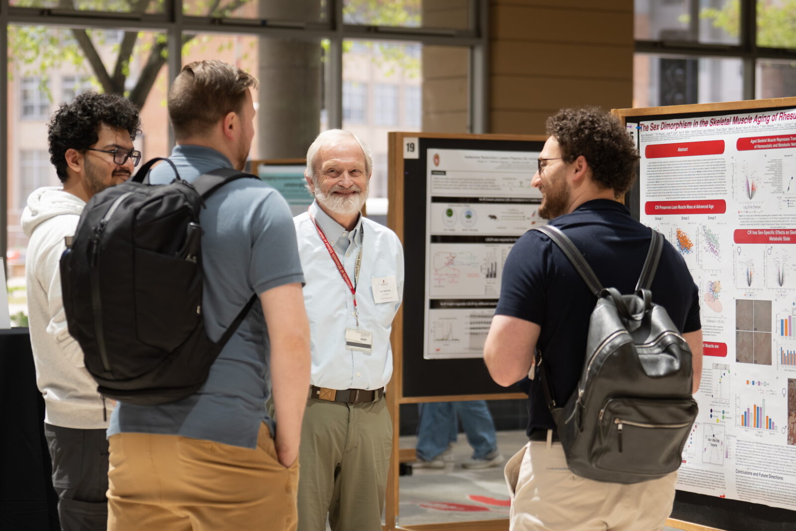 Image of attendees engaged in discussion during the WiNSC Symposium poster session and networking reception.
